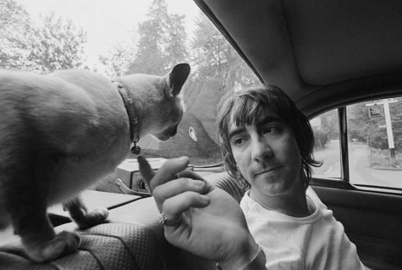 #13 The Who’s drummer Keith Moon riding in the backseat with his cat, 1970