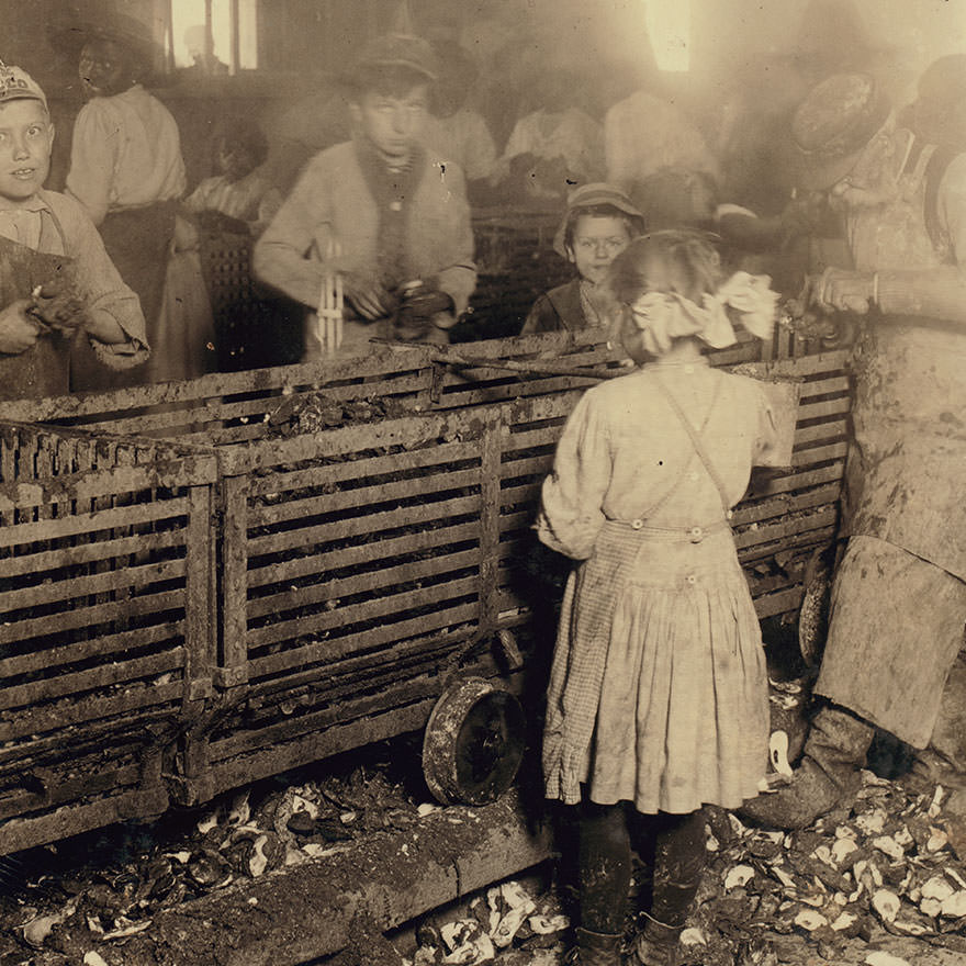 #30 Scene in canning factory showing a 7-year old girl who shucks 3 pots of oysters a day, and works regularly, and her 6-year old brother who helps some. Mostly negro workers. The boss said “we keep only enough whites so we can control the negroes and keep them agoing.” Location: Bluffton, South Caroli