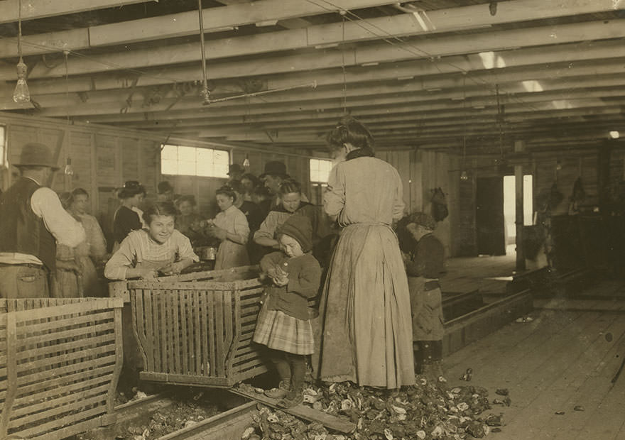 #12 Four-year-old Mary, who shucks two pots of oysters a day at Dunbar. Tends the baby when not working. Location: Dunbar, Louisiana