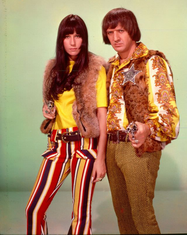 #6 Sonny Bono and Cher point guns toward the camera as they pose for a portrait. Photo by Michael Ochs Archives, 1970