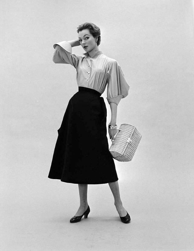 #12 Ivy in Givenchy’s skirt and blouse with wide 3/4 sleeves and exaggerated cuffs,February 1952