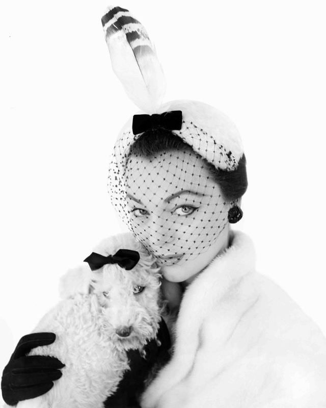 #27 Ivy Nicholson in Albouy’s white melusine cap, with black velvet bow, netted veil and feather, 1954