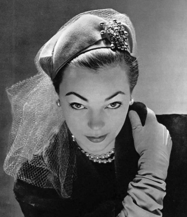 #3 Ivy Nicholson in green jersey hat decorated with net and jeweled pin by Jane Blanchot, 1951