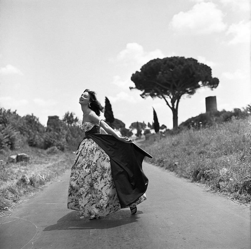 #41 Ivy Nicholson in evening gown by unidentified Italian designer, Appian Way, Rome, 1956