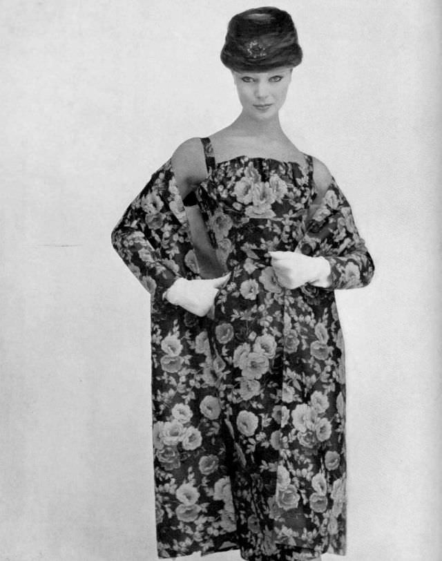 #42 Ivy Nicholson in multi-colored floral print on black silk gauze dress with matching coat by Nina Ricci, 1956