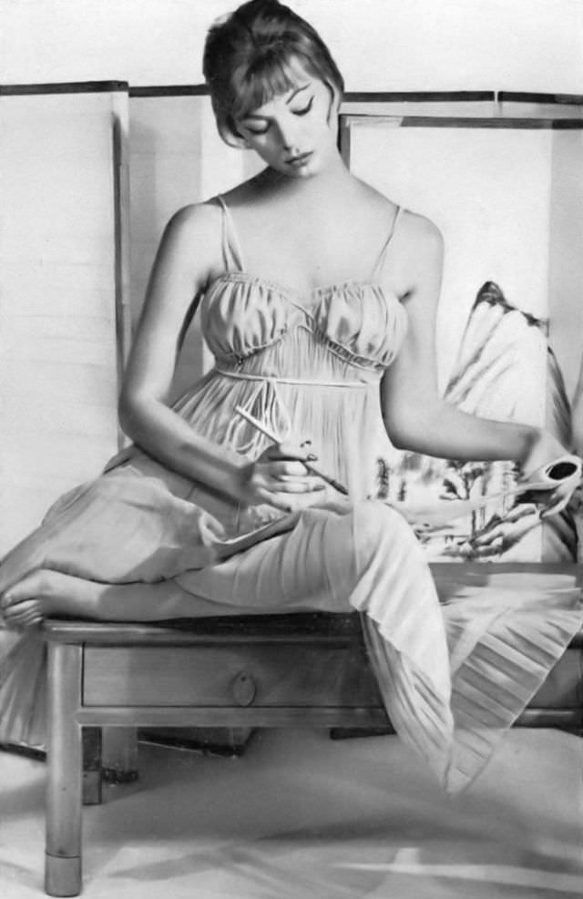 #47 Ivy Nicholson in crystal clear green pleated nightgown of nylon tricot, topped with shoestring straps, by Eye-Ful, Vogue, November 15, 1958
