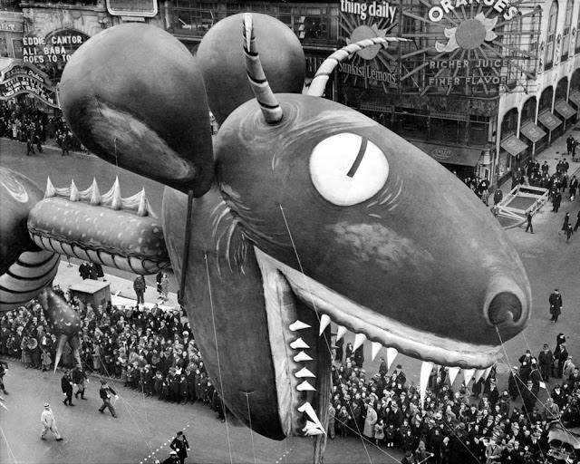 Sea serpent swoops down on crowds watching thirteenth annual Macy’s Thanksgiving Day parade on Broadway and 56th St., November 25, 1937.