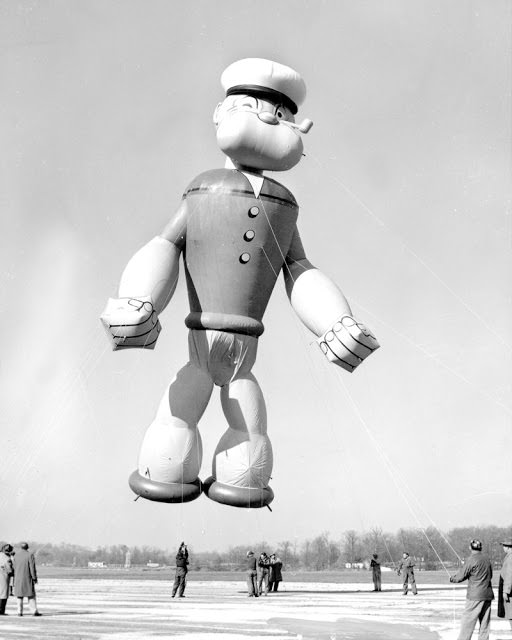 Popeye, the sailor, flexes his muscles as he gets ready to parade in Macy’s Thanksgiving Day parade in 1957. Popeye stands 56 feet tall, 32 feet wide and he’s filled with 6,000 cubic feet of helium.