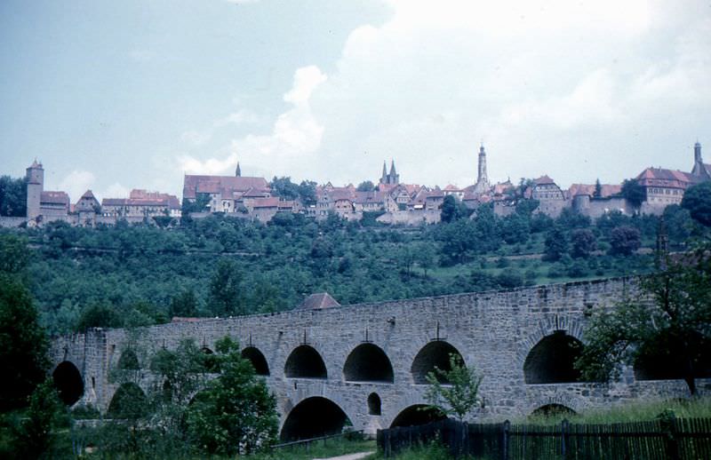 #50 Rothenburg’s skyline from the Tauber River valley. The famous “double bridge” is in the foreground. It was built around 1330