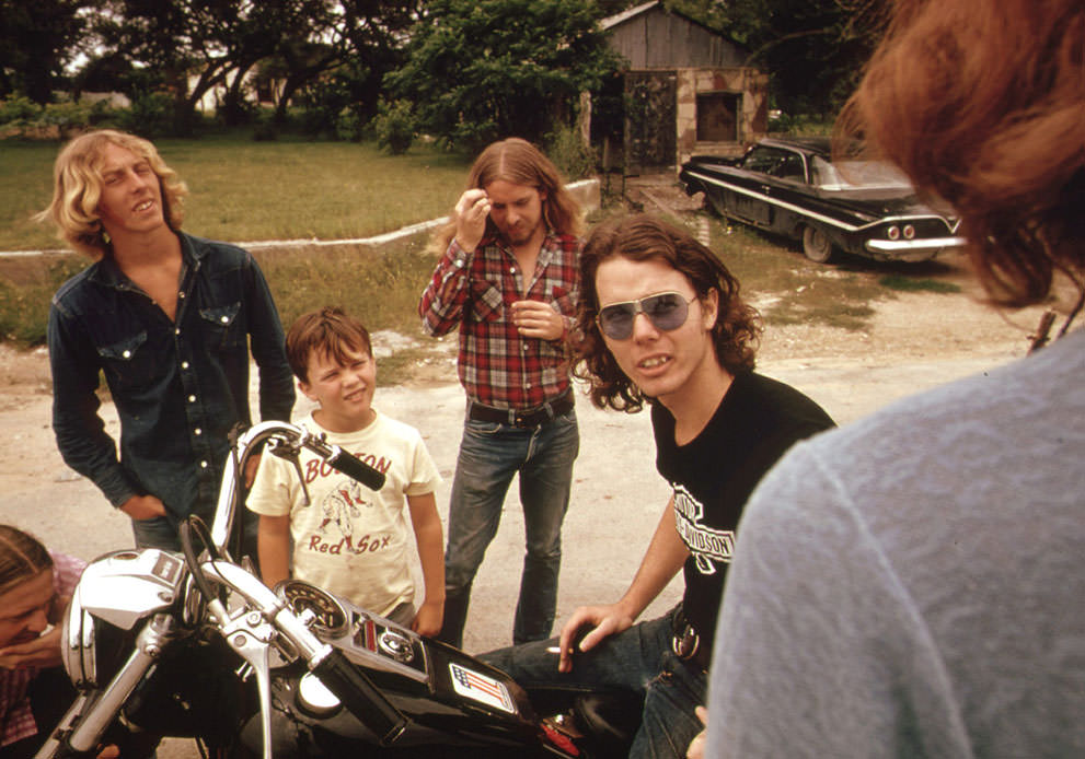 #35 Motorcyclist loading his possessions onto a truck with the help of his friends in Leakey, May 1973. (Marc St. Gil/NARA)