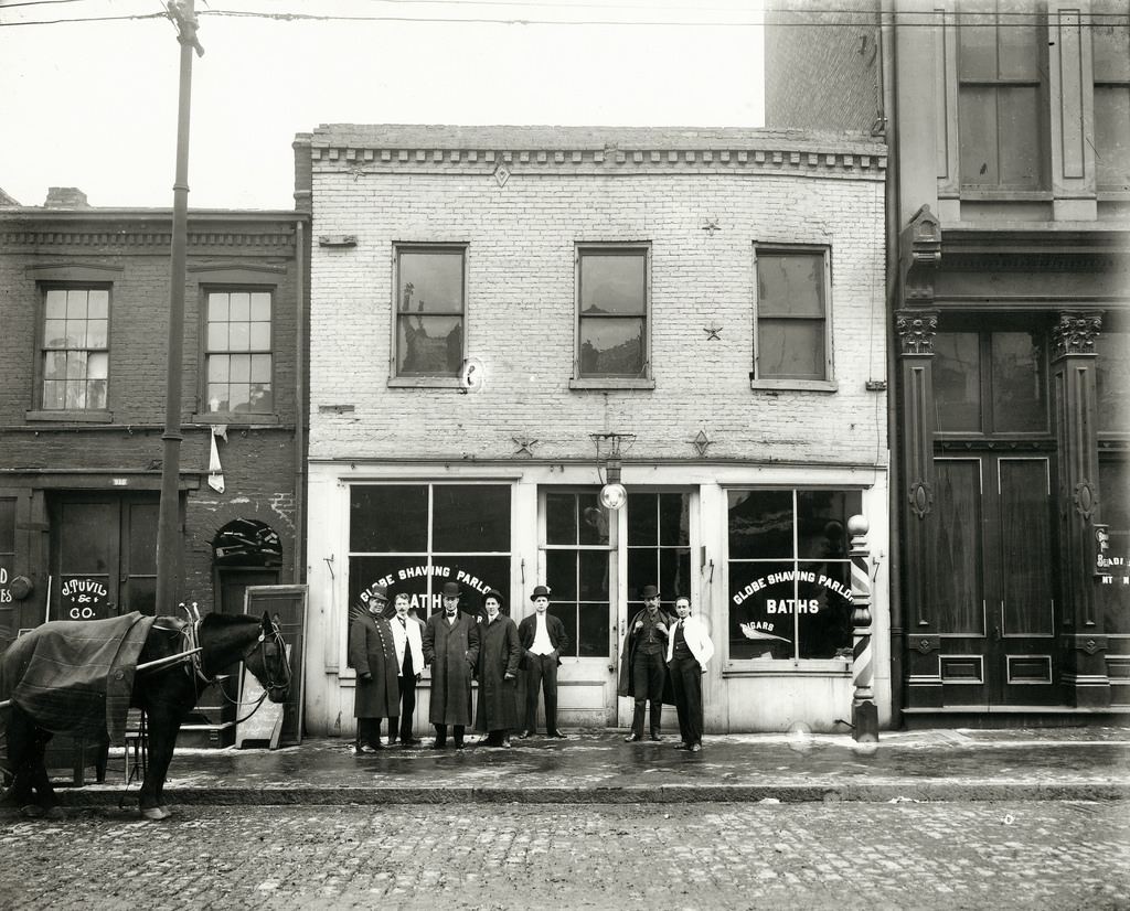 #43 Group of men standing in front of the Globe Shaving Parlor at 1015 Carr Street, ca. 1910