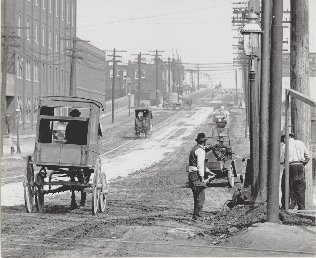 #63 Street workers and carriages on a street in St. Louis, ca. 1900s