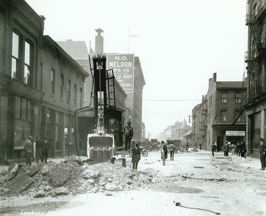 #74 Workers using a crane to tear up the road on Chestnut Street west of Ninth Street, 1914