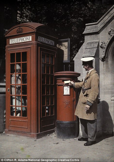 #11 A man posts a letter next to a traditional telephone box in Oxford in 1928