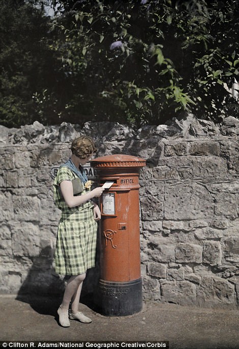 #15 A woman sends a letter at a red pillar box on the Isle of Wight in 1928