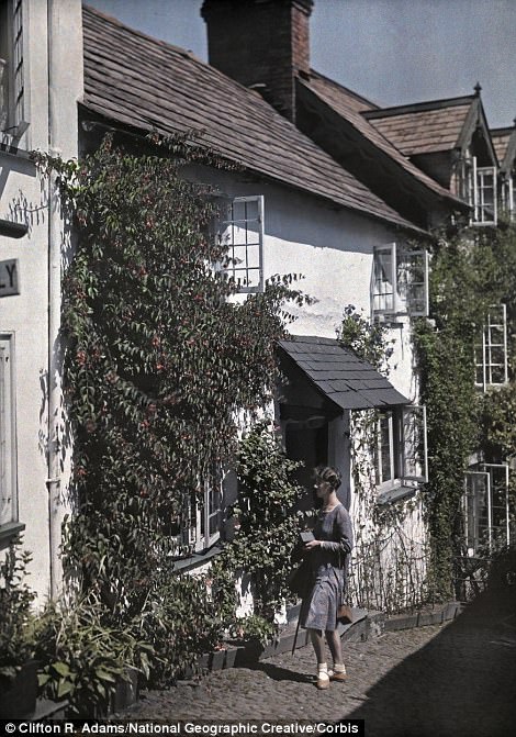#23 A woman walks on the street in Clovelly, 1931