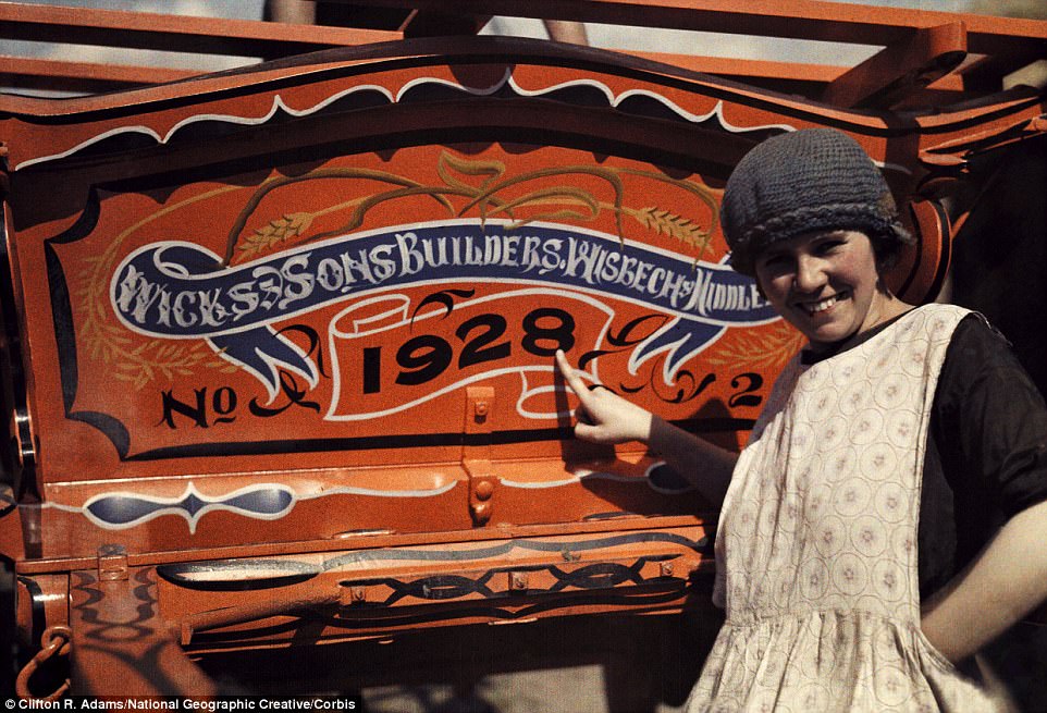 #28 An English woman points to her farm cart in Cambridgeshire, which bears the year before the photo was taken