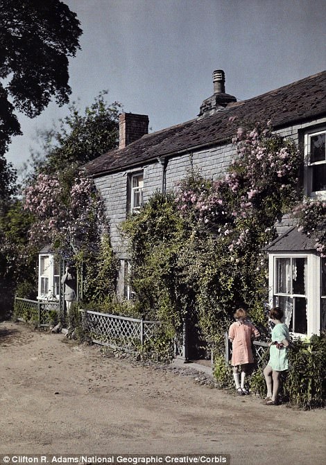 #32 Two girls talk outside a home in Chillington, Devon in 1928