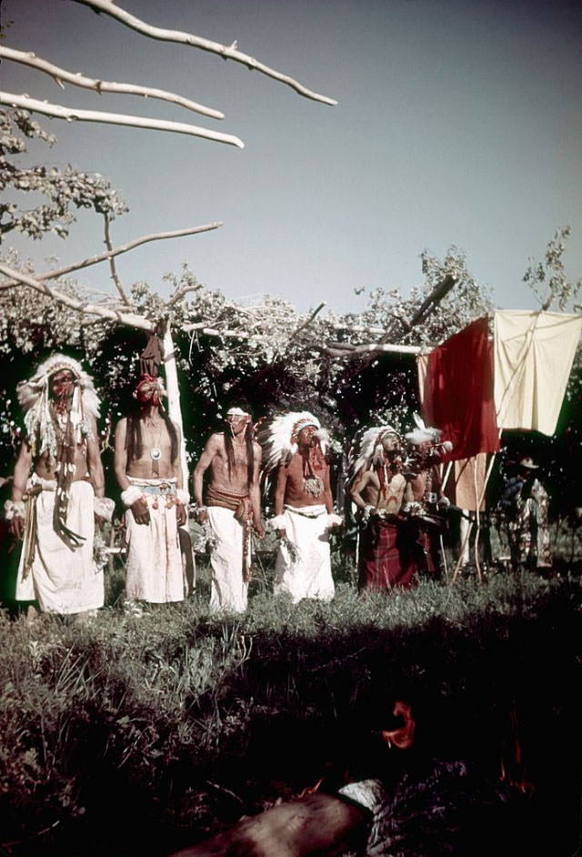 #31 Native Americans (possibly from the Lakota Sioux tribe) blow Eagle bone Whistles while participating in the Sun Dance.