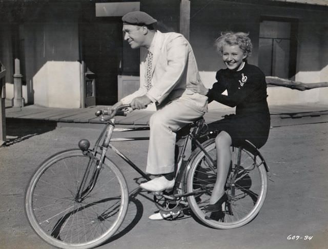 #21 William Newell and Sally Payne riding a bike, 1936