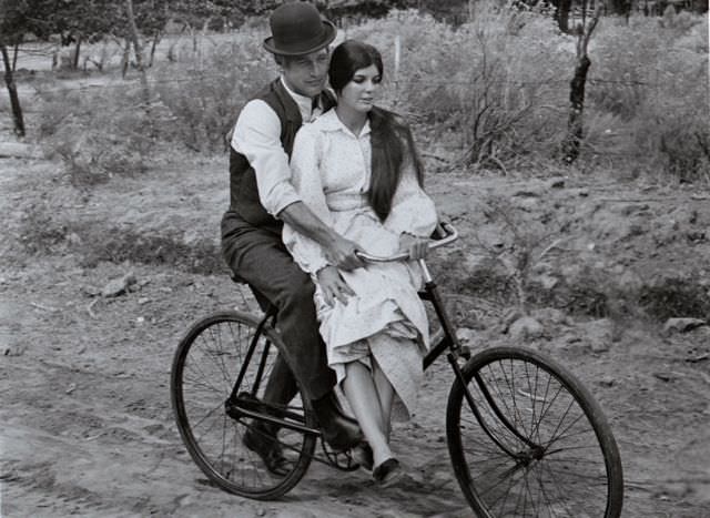 #25 Paul Newman and Katharine Ross riding a bike