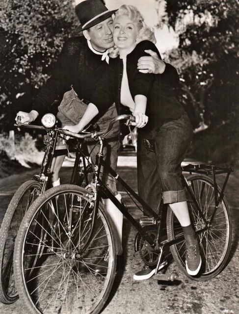 #39 Barry Sullivan and Lana Turner riding bikes.