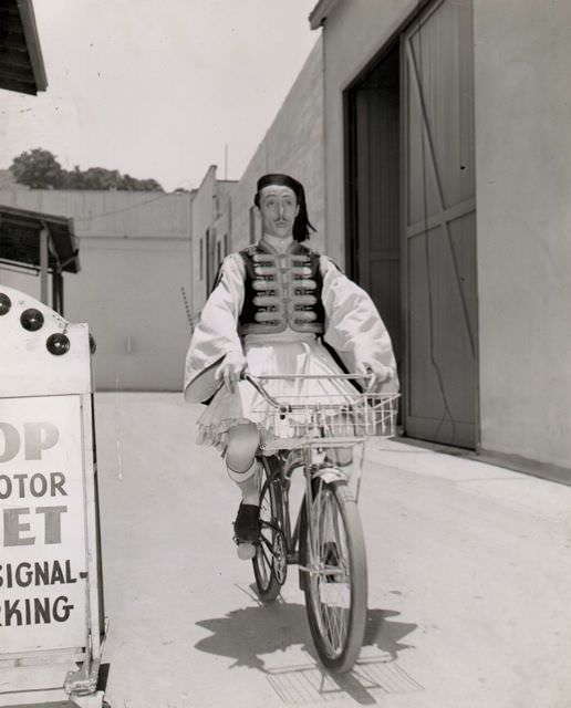 #40 Mischa Auer riding a bike.
