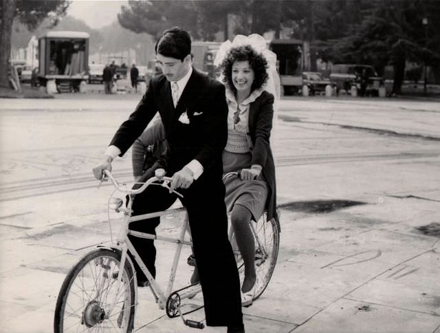 #44 Stefano Satta Flores and Monica Vitti ride a bike.