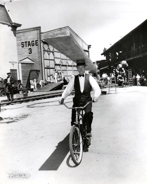 #52 Donald O’Connor riding a bike, Buster Keatonishly.