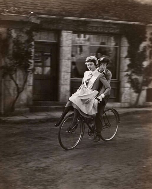 #53 Jennifer Jones and Brad Slaven ride a bike.