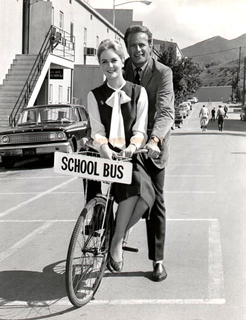 #56 Katherine Crawford and Jason Evers ride a bike.