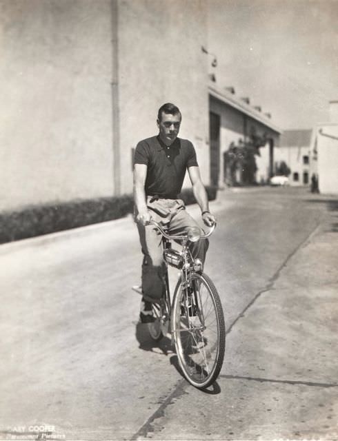 #57 Gary Cooper riding a bike.
