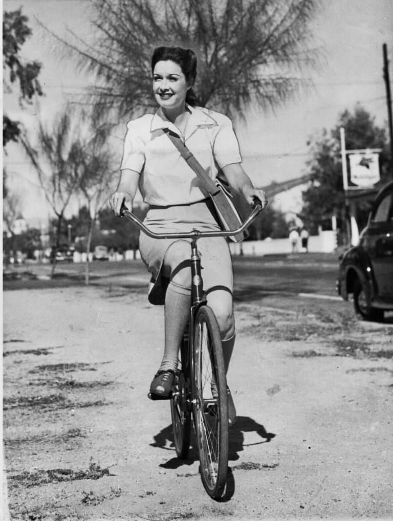 #20 Gail Patrick riding a bike.
