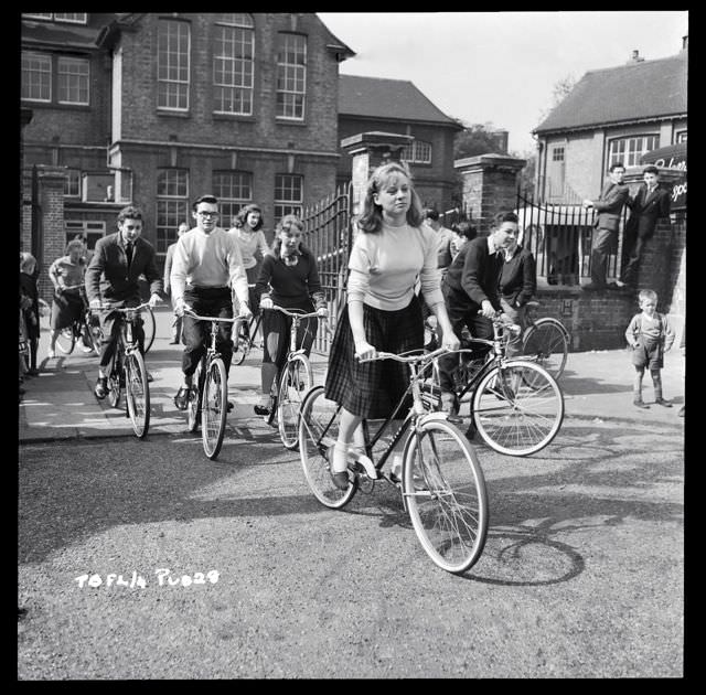 #27 Carol White, Jacqueline Lewis and George Howell ride bikes