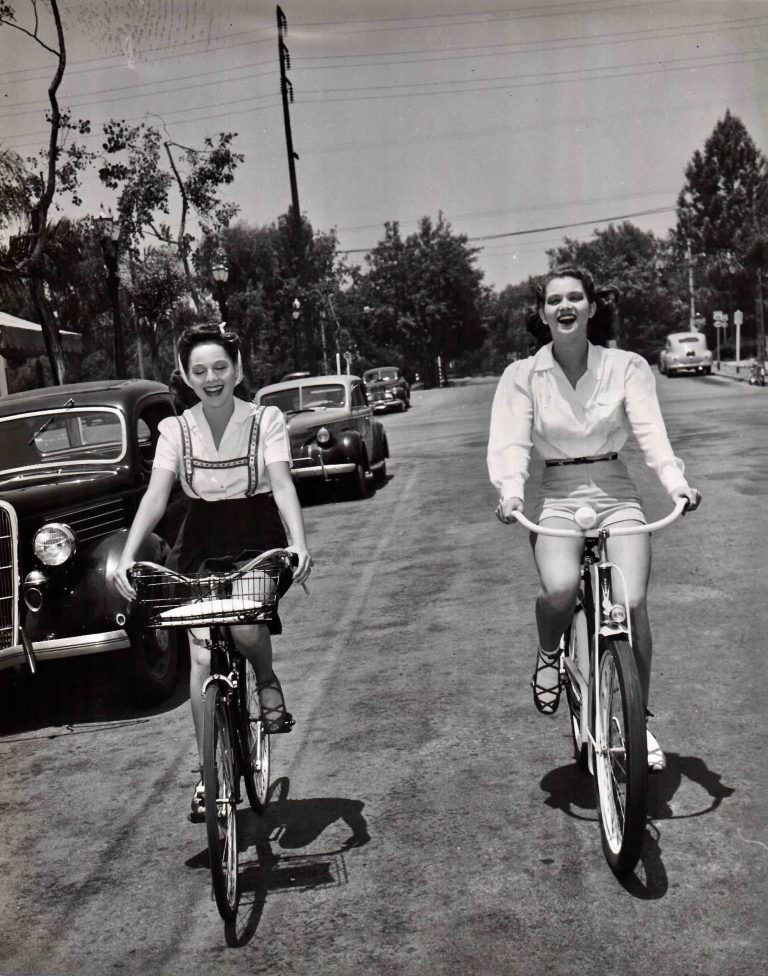 #8 Dorothy Morris and Frances Rafferty ride bikes.