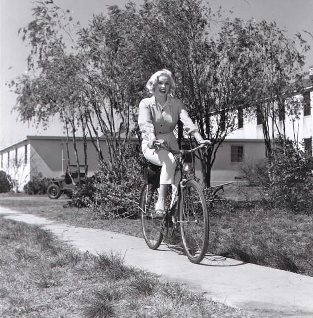 #37 Mamie Van Doren riding a bike.