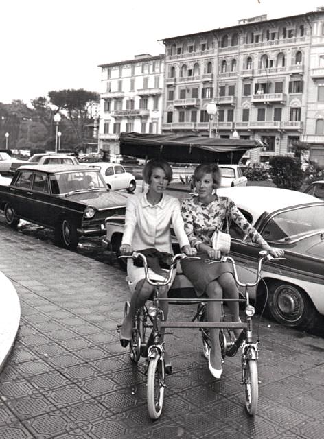 #40 Alice and Ellen Kessler ride a twin bike.