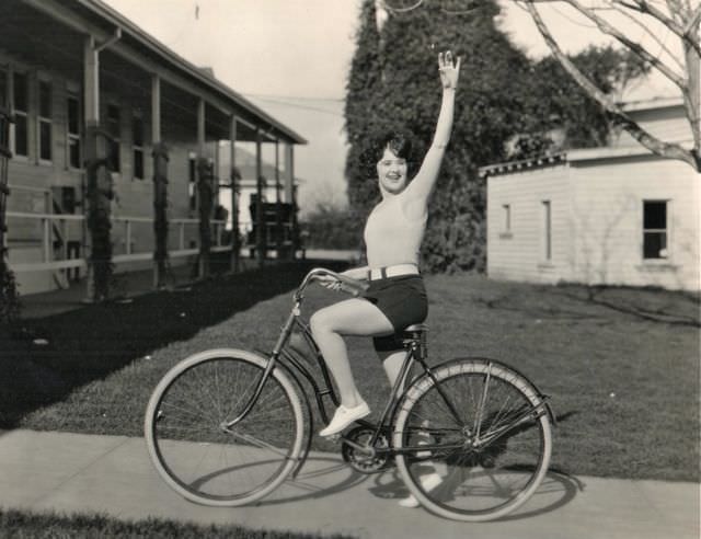 #2 Margaret Livingston riding a bike, waves hello. On the lot in 1924, three years before “Sunrise.”