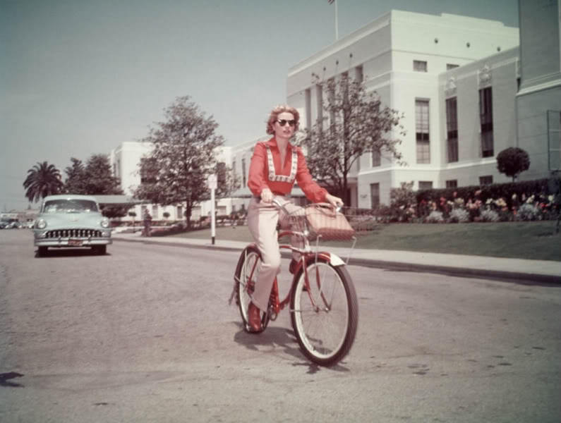 #46 Grace Kelly riding a bike.