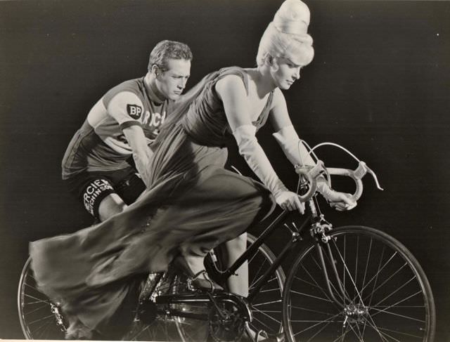 #49 Joanne Woodward and Paul Newman ride bikes.