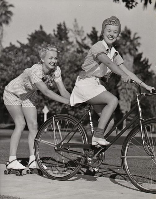 #4 Phyllis Ruth riding a bike, Carole Landis skitches on skates.