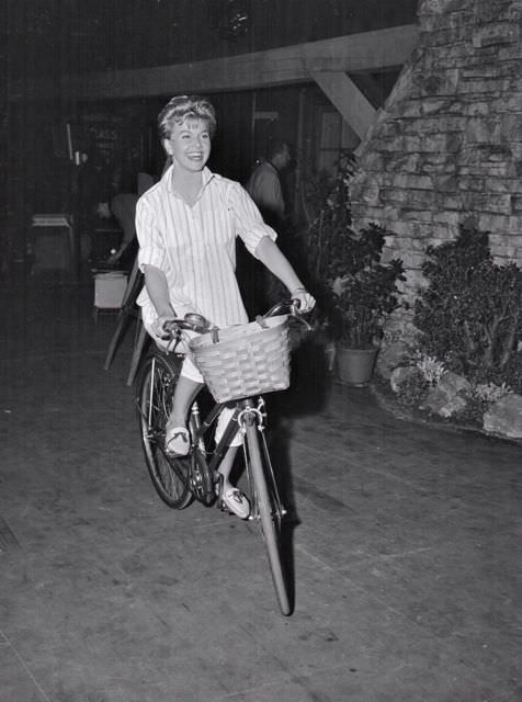 #51 Doris Day riding a bike.