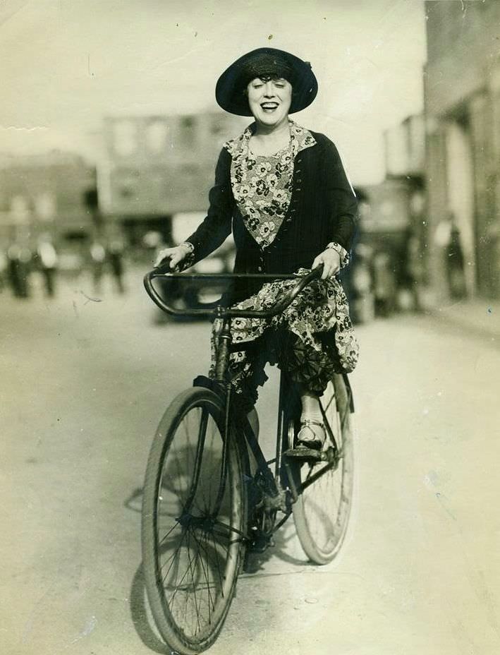 #6 Mabel Normand riding a bike.