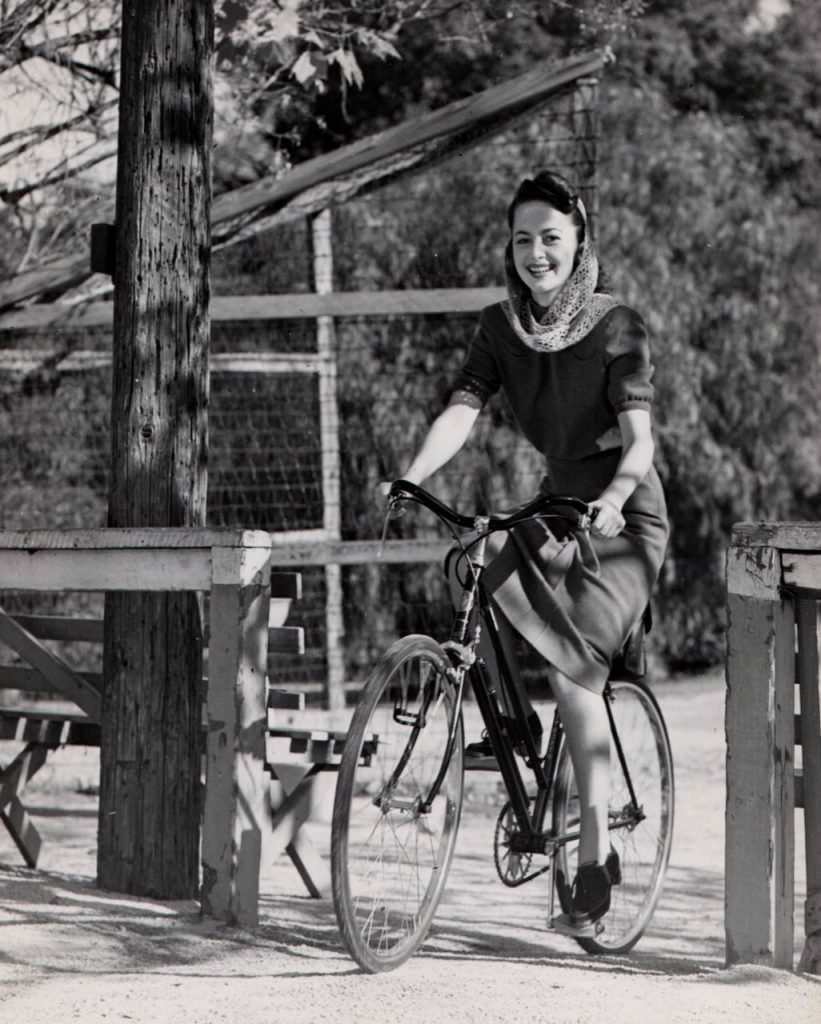 #57 Olivia de Havilland riding a bike. Happy 99th!