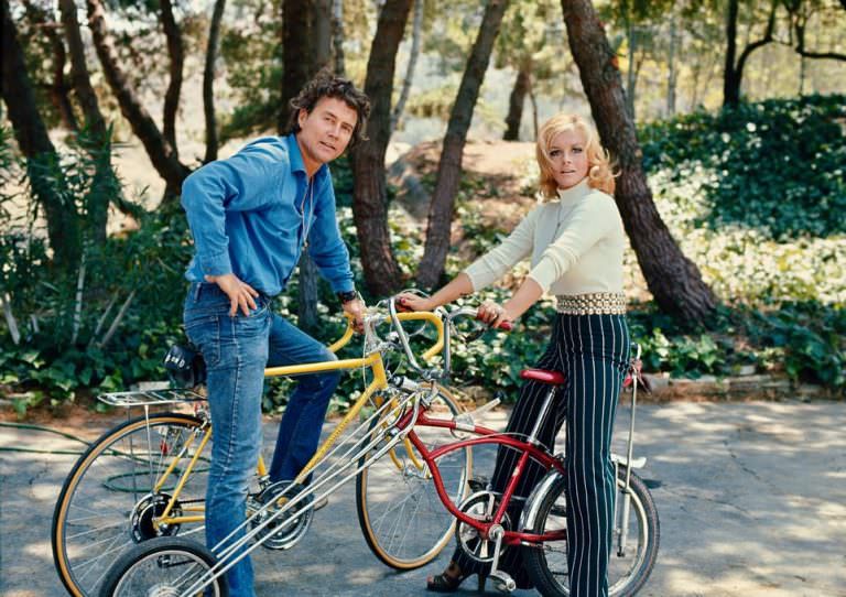 #1 Roger Smith and Ann-Margret posing with their bikes, 1972