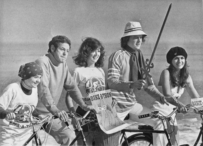 #12 Sandra Eisele, James MacArthur, Kathy Jordan, Bob Sirott and Gloria Besbekis posing with bikes.