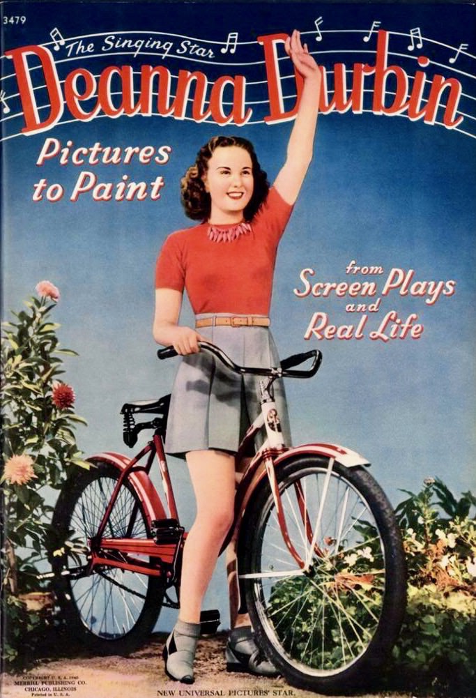 #15 Betsy Drake rests a bike, beach-side.