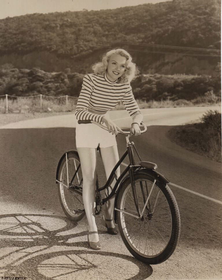 #21 Mickey Rooney, Cecilia Parker, Fay Holden and Lewis Stone on a bike.