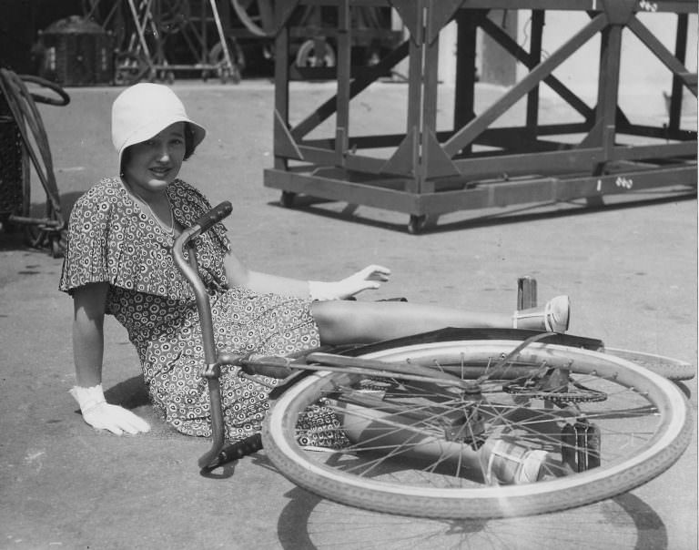 #25 Robin Askwith on a bike, Linda Hayden stops traffic.