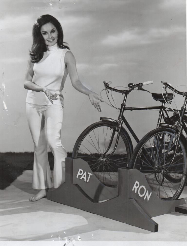 #36 Valerie Perrine and David Ackroyd holding a bike.
